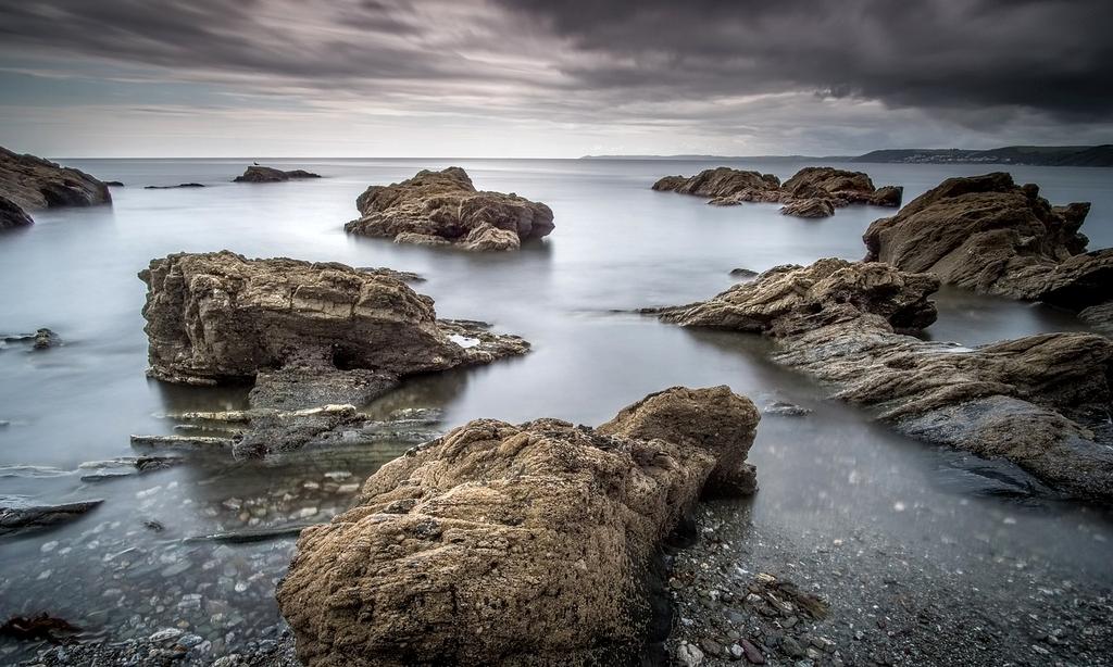 Coastal cliffs and sandy beach at Cornish coastline